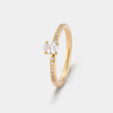 Ring AURA Oval in Gelbgold, Schrägansicht – quer gefasster ovaler Diamant, links und rechts begleitet von kleinen Diamanten auf der Ringschiene